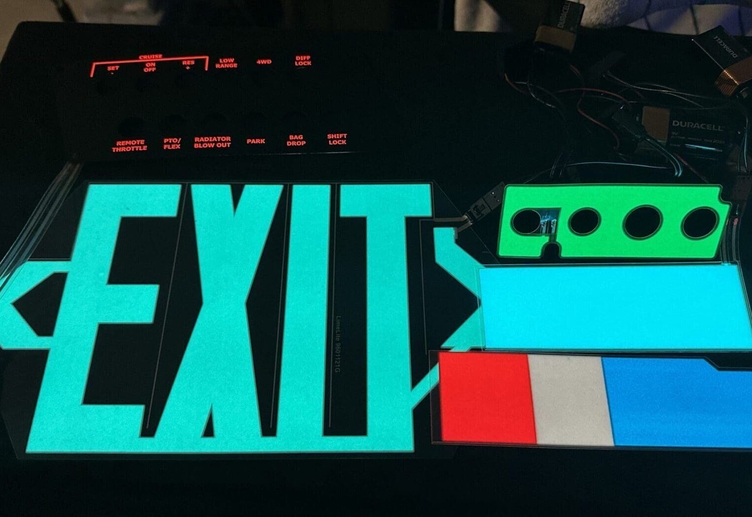 A close up of the exit sign lit up